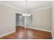 Charming dining room with hardwood floors, wainscoting detail, and elegant chandelier at 4546 Water Mill Dr, Buford, GA 30519