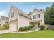Charming two-story home with stone accents, a well-manicured lawn, and an attached garage at 4546 Water Mill Dr, Buford, GA 30519