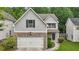Charming two-story home with stone accents, a two-car garage, and manicured landscaping at 4546 Water Mill Dr, Buford, GA 30519