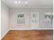 Bright room with light gray walls, three windows and wood-look flooring at 4546 Water Mill Dr, Buford, GA 30519