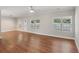 Spacious living area featuring light-filled windows, wood-look flooring, and a ceiling fan at 4546 Water Mill Dr, Buford, GA 30519