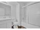 A bright bathroom features a shower-tub combo with sliding glass doors and a modern vanity at 5653 Bradley Cir, Lithonia, GA 30038