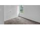Bedroom featuring neutral carpet, freshly painted walls and a sunlit window at 5653 Bradley Cir, Lithonia, GA 30038