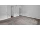 Bedroom featuring neutral carpet, freshly painted walls and multiple interior doors at 5653 Bradley Cir, Lithonia, GA 30038