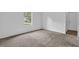 Bedroom featuring neutral carpet, freshly painted walls and a sunlit window at 5653 Bradley Cir, Lithonia, GA 30038