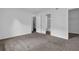 Bedroom featuring neutral carpet, freshly painted walls and open doorway to bathroom at 5653 Bradley Cir, Lithonia, GA 30038