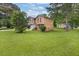 Two-story home featuring a manicured lawn, garage, and fresh landscaping at 5653 Bradley Cir, Lithonia, GA 30038