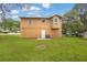Back exterior view of the home with a grassy backyard, perfect for outdoor entertaining and relaxation at 5653 Bradley Cir, Lithonia, GA 30038