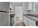 Kitchen featuring white cabinets, granite countertops, and stainless steel appliances at 5653 Bradley Cir, Lithonia, GA 30038