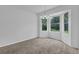 Neutral-toned carpeted room with abundant natural light and contemporary chandelier at 5653 Bradley Cir, Lithonia, GA 30038