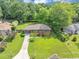 An overhead shot of a brick ranch home with lush landscaping and a covered carport at 701 Green Acres Se Rd, Smyrna, GA 30080