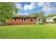 Expansive backyard featuring a lush lawn, chain-link fence and mature trees at 701 Green Acres Se Rd, Smyrna, GA 30080