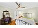 Cozy bedroom with hardwood floors, a ceiling fan, and a classic iron bed frame at 701 Green Acres Se Rd, Smyrna, GA 30080