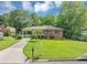 Charming brick home with a well-maintained lawn, a covered carport, and a neatly paved driveway at 701 Green Acres Se Rd, Smyrna, GA 30080