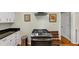 Modern kitchen with stainless steel oven, vent hood, white cabinets, and stylish decor at 701 Green Acres Se Rd, Smyrna, GA 30080