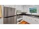 Updated kitchen featuring stainless steel appliances, white cabinets, and a window with backyard views at 701 Green Acres Se Rd, Smyrna, GA 30080