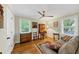 Inviting room with hardwood floors, sofa, two windows, and accent furniture at 701 Green Acres Se Rd, Smyrna, GA 30080