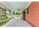Spacious covered patio featuring brick siding, a ceiling fan, and an outdoor living space at 701 Green Acres Se Rd, Smyrna, GA 30080