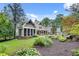 Lush backyard with landscaped garden, inviting pool, and screened-in porch at 114 Trinity Hollow Dr, Canton, GA 30115