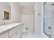 Bright bathroom featuring a white vanity with marble countertops, a toilet, and a glass-enclosed shower at 114 Trinity Hollow Dr, Canton, GA 30115