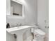 Neutral powder room featuring a pedestal sink, modern toilet, and decorative mirror at 114 Trinity Hollow Dr, Canton, GA 30115