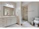 Clean bathroom featuring a tiled walk-in shower, marble countertops, and white cabinets at 114 Trinity Hollow Dr, Canton, GA 30115