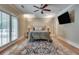 Primary bedroom with a king bed, natural light, and a door leading to an outdoor space at 114 Trinity Hollow Dr, Canton, GA 30115