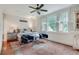 Bedroom features a large area rug, two chairs, and bright natural light from the windows at 114 Trinity Hollow Dr, Canton, GA 30115