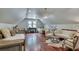 Spacious bonus room with hardwood floors, beds, seating, and unique light fixtures at 114 Trinity Hollow Dr, Canton, GA 30115