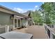 Spacious deck with hot tub, awning-covered french doors, and railing overlooking lush greenery at 114 Trinity Hollow Dr, Canton, GA 30115