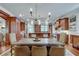 Elegant dining room with wood cabinetry and center table adjacent to an open-concept kitchen at 114 Trinity Hollow Dr, Canton, GA 30115