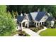 Beautiful home with lush landscaping, manicured lawn, and a circular driveway at 114 Trinity Hollow Dr, Canton, GA 30115
