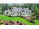 Beautiful home showing large lawn area, mature trees and impeccable landscaping at 114 Trinity Hollow Dr, Canton, GA 30115