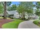 Two story home with portico, manicured landscaping, and circular driveway at 114 Trinity Hollow Dr, Canton, GA 30115