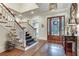 Grand foyer featuring hardwood floors, staircase, and decorative furnishings for a welcoming entrance at 114 Trinity Hollow Dr, Canton, GA 30115