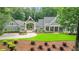 Stately home featuring a portico over the driveway and meticulous landscaping at 114 Trinity Hollow Dr, Canton, GA 30115
