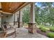 Covered porch with stone accents, wood ceiling, and rocking chairs at 114 Trinity Hollow Dr, Canton, GA 30115