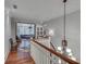 Hallway with hardwood floors, a staircase, a decorative chandelier, and a view of the open-concept living area at 114 Trinity Hollow Dr, Canton, GA 30115