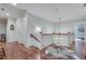 Bright hallway with hardwood floors, white trim, and staircase leading to the upper level at 114 Trinity Hollow Dr, Canton, GA 30115