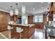 Modern kitchen with stainless steel appliances, granite countertops, island, and hardwood floors at 114 Trinity Hollow Dr, Canton, GA 30115