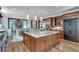 Gourmet kitchen with granite island, custom cabinets, and seamless transition to breakfast area at 114 Trinity Hollow Dr, Canton, GA 30115