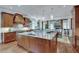 Well-equipped kitchen with granite countertops, gas range, custom wood cabinets, and adjacent dining area at 114 Trinity Hollow Dr, Canton, GA 30115