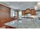 A spacious kitchen featuring wood cabinets, granite countertops, and stainless steel appliances at 114 Trinity Hollow Dr, Canton, GA 30115