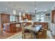 Gourmet kitchen with wood cabinetry, granite counters, large island, and adjacent dining area at 114 Trinity Hollow Dr, Canton, GA 30115