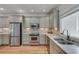A well-lit kitchen features stainless steel appliances, granite countertops, and wood flooring at 114 Trinity Hollow Dr, Canton, GA 30115