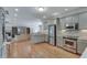 An open-concept kitchen with stainless steel appliances and a breakfast bar flows into the living space at 114 Trinity Hollow Dr, Canton, GA 30115