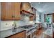 Modern kitchen with stainless steel appliances, custom wood cabinets and granite countertops at 114 Trinity Hollow Dr, Canton, GA 30115