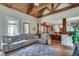 Cozy living room with hardwood floors, a sectional sofa, and a glimpse into the open dining area at 114 Trinity Hollow Dr, Canton, GA 30115
