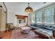 Cozy living room with a built-in bed, large windows, stylish furniture, and an eye-catching pendant light at 114 Trinity Hollow Dr, Canton, GA 30115