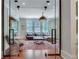 Sophisticated living room featuring an area rug, pendant light, and glass doors leading to the staircase at 114 Trinity Hollow Dr, Canton, GA 30115